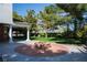 Outdoor space with fire pit, lush landscaping and mature trees at 5860 N Campbell Rd, Las Vegas, NV 89149