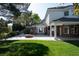 Lush backyard featuring a well-manicured lawn, covered patio, and cozy fire pit area at 5860 N Campbell Rd, Las Vegas, NV 89149