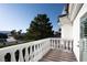 Balcony with white railing offering views of the neighborhood and surrounding trees at 5860 N Campbell Rd, Las Vegas, NV 89149