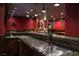 Wet bar with stainless steel beer tap and theater room in the background at 5860 N Campbell Rd, Las Vegas, NV 89149