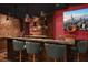 Home bar featuring dark wood cabinetry, a sink, and custom lighting at 5860 N Campbell Rd, Las Vegas, NV 89149