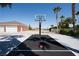 The basketball court adjacent to the garages allows for Gathering-friendly fun and recreation at 5860 N Campbell Rd, Las Vegas, NV 89149