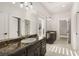 Bright bathroom with double vanity, stone countertop, and a walk-in shower with glass door at 5860 N Campbell Rd, Las Vegas, NV 89149
