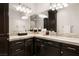 Bathroom vanity with dark wood cabinets, marble countertops, and a large mirror at 5860 N Campbell Rd, Las Vegas, NV 89149