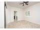 A serene bedroom with a ceiling fan, neutral carpet, and a door leading to the bathroom at 5860 N Campbell Rd, Las Vegas, NV 89149