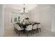 Dining room featuring a modern table with seating for ten and a decorative chandelier at 5860 N Campbell Rd, Las Vegas, NV 89149