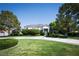 Well-maintained home featuring a circular driveway and lush front yard with mature trees at 5860 N Campbell Rd, Las Vegas, NV 89149