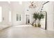 Bright foyer featuring high ceilings, a grand staircase, and elegant light fixture at 5860 N Campbell Rd, Las Vegas, NV 89149