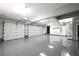 Spacious garage with epoxy floors, overhead lighting, shelving, and ample storage space at 5860 N Campbell Rd, Las Vegas, NV 89149