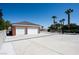 Spacious detached two car garage with red brick and expansive driveway with basketball hoop at 5860 N Campbell Rd, Las Vegas, NV 89149