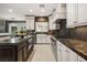 Modern kitchen features white cabinets, stainless steel appliances, and a stone backsplash at 5860 N Campbell Rd, Las Vegas, NV 89149