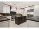Spacious kitchen features stainless appliances, a center island, and granite countertops at 5860 N Campbell Rd, Las Vegas, NV 89149