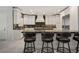 Bright kitchen features a center island with bar seating, perfect for entertaining at 5860 N Campbell Rd, Las Vegas, NV 89149