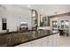 Open-concept living room and kitchen with stone accent wall and luxury finishes at 5860 N Campbell Rd, Las Vegas, NV 89149