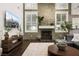 Bright living room with stone accent wall, fireplace, and dark hardwood floors at 5860 N Campbell Rd, Las Vegas, NV 89149