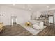 Bright, open-concept living room with modern décor, a large mirror and hardwood flooring at 5860 N Campbell Rd, Las Vegas, NV 89149