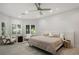 Comfortable main bedroom with bright lighting, shutters, and a seating area at 5860 N Campbell Rd, Las Vegas, NV 89149