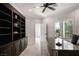 Bright home office with custom built-in shelving and modern ceiling fan at 5860 N Campbell Rd, Las Vegas, NV 89149