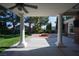 Spacious covered patio with ceiling fans overlooking a green backyard and fire pit at 5860 N Campbell Rd, Las Vegas, NV 89149
