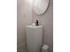 Modern powder room features a pedestal sink, black faucet, and minimalist decor at 5860 N Campbell Rd, Las Vegas, NV 89149