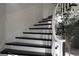 Elegant staircase features dark wood steps, white risers, and a curved white banister at 5860 N Campbell Rd, Las Vegas, NV 89149