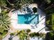 Aerial view of private pool with rock waterfall feature, diving board, and surrounded by mature landscaping at 5860 N Campbell Rd, Las Vegas, NV 89149