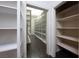 Expansive walk-in closet with ample shelving and dark wood floors, providing storage solutions at 5860 N Campbell Rd, Las Vegas, NV 89149