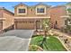Charming two-story home features a well-maintained lawn, complemented by a two car garage and a stone facade at 6053 Lambert Bridge Ave, Las Vegas, NV 89139