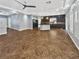 Spacious living room with an open layout featuring dark cabinetry, granite countertops, and tile flooring at 6053 Lambert Bridge Ave, Las Vegas, NV 89139