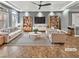 Bright living room with stylish furnishings, including a sofa, chairs, and a modern ceiling fan and recessed lights at 6053 Lambert Bridge Ave, Las Vegas, NV 89139