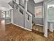 View of stairway with gray walls, carpeted stairs, tile landing, and view of a half bathroom at 6053 Lambert Bridge Ave, Las Vegas, NV 89139