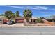 Charming single-story home features a two-car garage and desert landscaping with a secure chain link fence at 625 Fernbrook Dr, Henderson, NV 89002