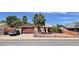 Charming single-story home features a two-car garage and desert landscaping with a secure chain link fence at 625 Fernbrook Dr, Henderson, NV 89002
