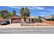 Charming single-story home features a two-car garage and desert landscaping with a secure chain link fence at 625 Fernbrook Dr, Henderson, NV 89002