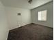 A simple bedroom featuring a window, carpet, and a wall-mounted air conditioning unit at 641 West St, Pahrump, NV 89048