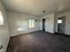 A bedroom featuring neutral walls, carpet, a window, and closet space with a view into an ensuite bathroom at 641 West St, Pahrump, NV 89048