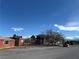 Exterior shot of the brown single story property and the other surrounding buildings at 641 West St, Pahrump, NV 89048