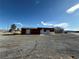 Spacious exterior with ample parking and functional building with various entry doors at 641 West St, Pahrump, NV 89048
