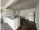 Kitchen and eating area with hardwood floors and new white appliances at 641 West St, Pahrump, NV 89048