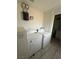 Bright laundry room featuring a washer, dryer, and space-saving wall-mounted water heater at 641 West St, Pahrump, NV 89048