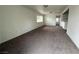 Spacious living room with carpeted floors and a large window at 641 West St, Pahrump, NV 89048