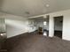 Open concept living space with a view of a kitchen, neutral walls, and carpeted flooring at 641 West St, Pahrump, NV 89048