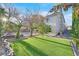 Lush backyard featuring green artificial turf and mature trees at 65 Pangloss St, Henderson, NV 89002