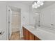 Bathroom featuring a light countertop vanity, wood cabinets, and neutral colored walls at 65 Pangloss St, Henderson, NV 89002