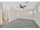 Bedroom featuring neutral walls, carpet flooring, and a doorway to a bathroom at 65 Pangloss St, Henderson, NV 89002
