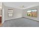 Bedroom with neutral walls, carpet flooring, and large windows providing outdoor views at 65 Pangloss St, Henderson, NV 89002