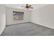 Bedroom with neutral walls, carpet flooring and a window with outdoor views at 65 Pangloss St, Henderson, NV 89002