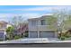Charming two-story home featuring an attached two-car garage, and desert landscaping at 65 Pangloss St, Henderson, NV 89002