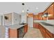 Modern kitchen with an island, stainless steel appliances, and tiled floors at 65 Pangloss St, Henderson, NV 89002