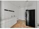 Functional laundry area featuring a sink, storage cabinets, and a full-size refrigerator for added convenience at 65 Pangloss St, Henderson, NV 89002
